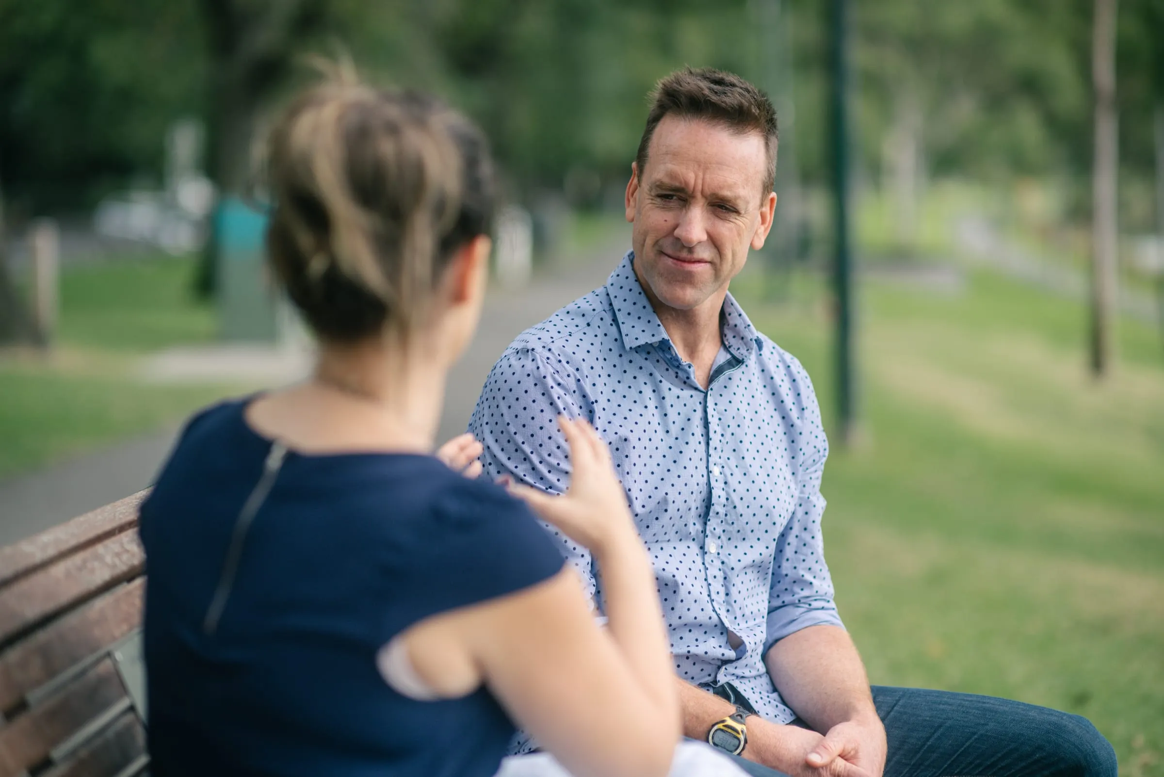 Scott in a relaxed conversation on a park bench